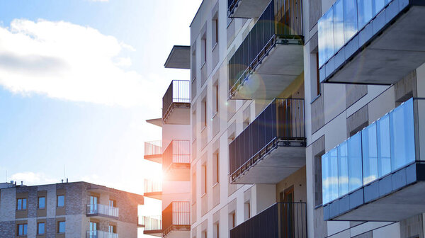 Modern apartment building in sunny day. Exterior, residential house facade. Residential area with modern, new and stylish living block of flats.