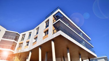 Eşsiz bir mimari çözümü olan bir apartman. Beyaz cepheli ve yüksek beton sütunların üzerinde duran modern bir yerleşim yeri..