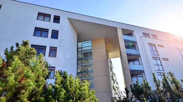 Eco city with modern exterior design of apartment building and landscaping. Garden yard by residential buildings.. Contemporary eco friendly residential architecture. Eco-friendly living in a city.