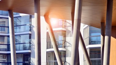 Eşsiz bir mimari çözümü olan bir apartman. Beyaz cepheli ve yüksek beton sütunların üzerinde duran modern bir yerleşim yeri..