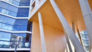 Eşsiz bir mimari çözümü olan bir apartman. Beyaz cepheli ve yüksek beton sütunların üzerinde duran modern bir yerleşim yeri..