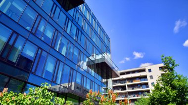 Karbondioksiti azaltmak için ağaçlı sürdürülebilir cam ofis binası. Modern şehirde çevre dostu bir bina. Yeşil çevresi olan bir ofis. Şirket binası CO2 'yi düşürdü.