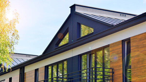 Terraced residential homes with modern facade in newly developed housing estate. The real estate market in the suburbs. New terraced houses in a new development area.