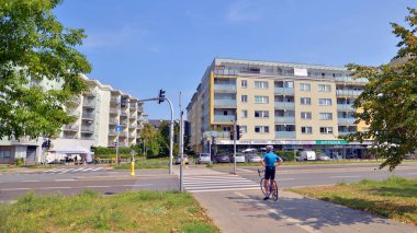 Warsaw, Poland. 24 August 2024. Ursynow district intensive residential developments in this modern residential buildings and wide streets with pedestrian and car traffic near Las Kabacki Forest. clipart