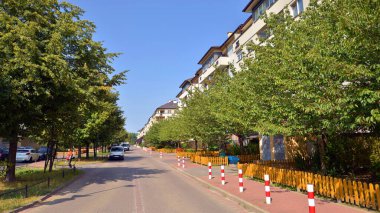 Warsaw, Poland. 24 August 2024. Ursynow district intensive residential developments in this modern residential buildings and wide streets with pedestrian and car traffic near Las Kabacki Forest. clipart