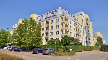 Warsaw, Poland. 24 August 2024. Ursynow district intensive residential developments in this modern residential buildings and wide streets with pedestrian and car traffic near Las Kabacki Forest. clipart