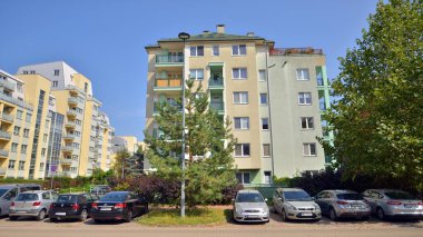 Warsaw, Poland. 24 August 2024. Ursynow district intensive residential developments in this modern residential buildings and wide streets with pedestrian and car traffic near Las Kabacki Forest. clipart