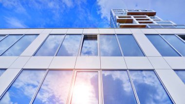 Çok katlı, modern bir apartmanın dış cephesi, pencereleri ve balkonları..