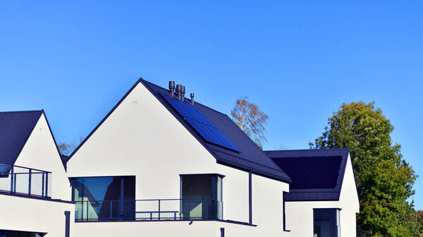 New elegant modern single family house. Terraced family homes in newly developed housing estate. Facade of a modern house with white walls. Real estate concept, european style.  