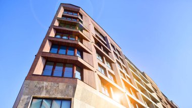 Modern Avrupa apartmanı. Mimarlık ve gayrimenkul, panoramik pencereli bir apartman. Mavi gökyüzü arka planına sahip modern kompleks.