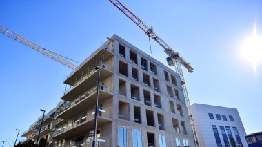 Yeni çok katlı modern apartmanlar güneşli bir günde yapım aşamasında.