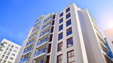 Cam balkonlu yeni apartman. Deniz kenarındaki modern mimari evler. Binanın ön cephesinde büyük camlar var..