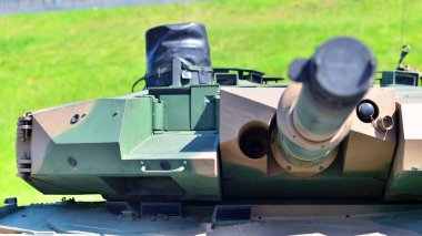 Ağır askeri tank aracı taret silahı hedefe nişan aldı ve ateşe hazır. Bir tankın döner taret namlusu ucu. Modern bir tankın taret namlusuyla detaylı çekim..