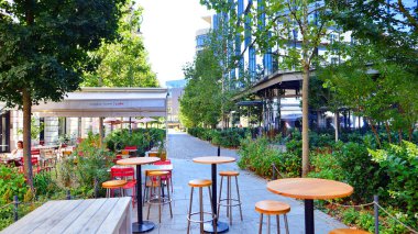 Warsaw, Poland. 21 September 2025. Bracka in downton lined with granite slabs and planted with plants and shrubs street. City promenade during summer day. City architecture with shops and greenery.