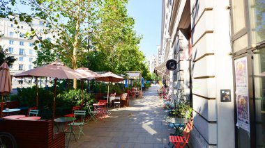 Warsaw, Poland. 21 September 2025. Bracka in downton lined with granite slabs and planted with plants and shrubs street. City promenade during summer day. City architecture with shops and greenery.