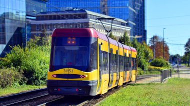 Warsaw, Poland. 26 September 2025. Yellow tram. Downtown street traffic on Towarowa street on summer day.