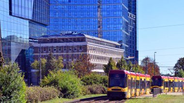 Warsaw, Poland. 26 September 2025. Yellow tram. Downtown street traffic on Towarowa street on summer day.