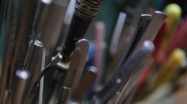 Farklı kulplara sahip çeşitli metal araçların yakın plan görüntüsü, ayrıntılı ve desenli bir kompozisyon oluşturma, işçilik ve kamu hizmetleri