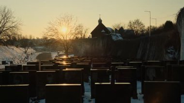 Gün batımında gün batımında parlayan mezar taşlarıyla anıları canlandıran, yas tutan ve yaşam döngüsünü anımsatan bir mezarlık.