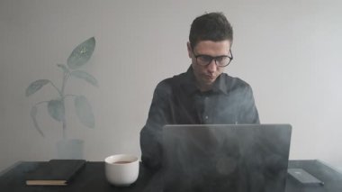 Son teslim tarihi baskısı. Dizüstü bilgisayarındaki stresli adam projenin son teslim tarihinin baskısını hissediyor. Bitkin düşmek. Ofis çalışanı çoklu görevle boğuşuyor.