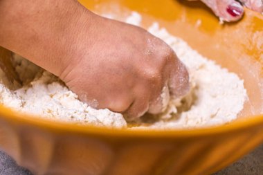 Close-up of a chef's hands making crostata Italian cheese and chocolate cake. Cook mixing dough