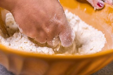 Close-up of a chef's hands making crostata Italian cheese and chocolate cake. Cook mixing dough