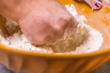 Close-up of a chef's hands making crostata Italian cheese and chocolate cake. Cook mixing dough