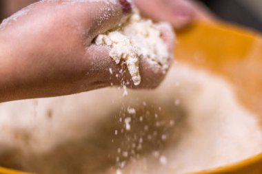 Close-up of a chef's hands making crostata Italian cheese and chocolate cake. Cook mixing dough