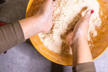 Close-up of a chef's hands making crostata Italian cheese and chocolate cake. Cook mixing dough