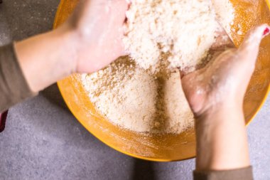 Close-up of a chef's hands making crostata Italian cheese and chocolate cake. Cook mixing dough
