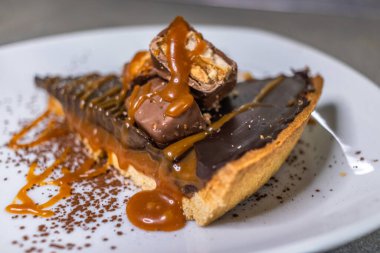 Dark chocolate and caramel cake on a plate