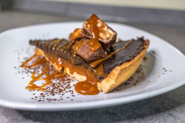 Dark chocolate and caramel cake on a plate