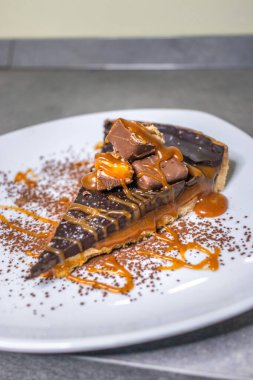 Dark chocolate and caramel cake on a plate