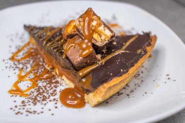 Dark chocolate and caramel cake on a plate