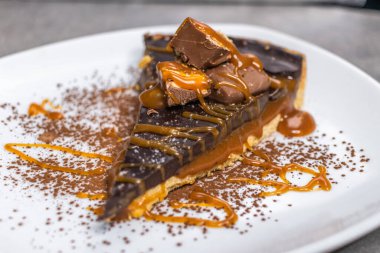 Dark chocolate and caramel cake on a plate