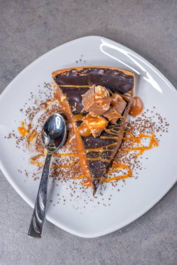 Dark chocolate and caramel cake on a plate