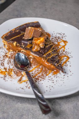 Dark chocolate and caramel cake on a plate