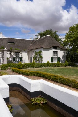 Swellendam, South Africa - 18 November 2022: Historic buildings in the Cape Dutch style of architecture that form the Drostdy Museum in Swellendam, Western Cape, South Africa
