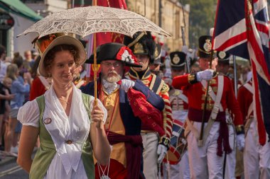 Bath, England, United Kingdom - 9 September 2023: Parade of people dressed in period costume from the Georgian era as part of the annual Jane Austen festival in Bath in Somerset, United Kingdom                                 clipart