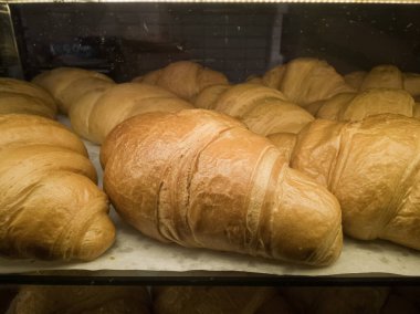 Freshly baked croissants on a bake board, close-up.