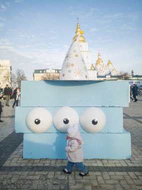 A child at a concrete fortification disguised as a funny character in the concept 