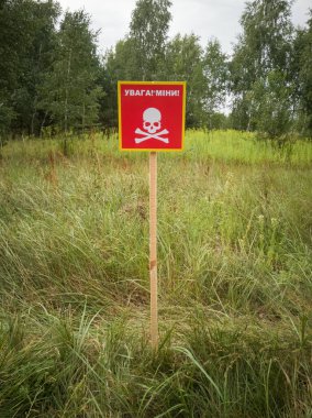 Ukrainian mine danger sign in the forest. Translation: 
