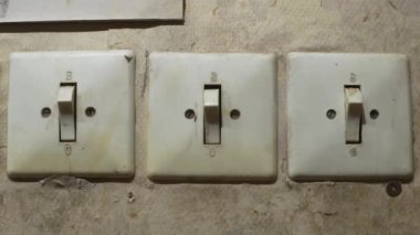 Old vintage plastic switches on an old abandoned wall. Dolly.