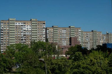 Sıcak bir yaz gününde, çok katlı prefabrik bir panelin aşırı kalabalık, pejmürde apartmanlarının ön cephesi. Kyiv, Ukrayna - 25 Mayıs 2024