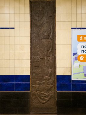 Decorative metal panel with carving depicting Kyiv during the Rus' era on the railway wall at the Poshtova Ploshcha metro station. Kyiv, Ukraine - February 5, 2025 clipart