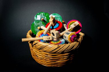 A beautifully arranged basket showcasing traditional and artisanal Mexican toys against a black background clipart