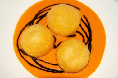 Exquisite parmesan spheres served with a rich and smoky roasted pepper sauce clipart