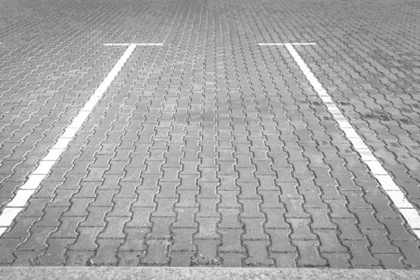 Parking without cars. Empty parking space. Life in the city. Concrete jungle. Concrete tile. Marking in the car park.