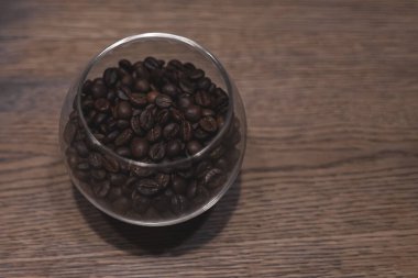 Roasted coffee beans in a glass. Hot coffee. Fragrant morning drink.