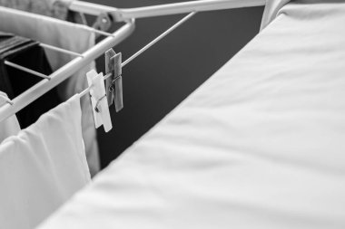 White color. Clothespins on the dryer. Things dry after washing. Fresh smell. Clean linen. To wash things. White stuff. 